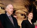 Sir Edmund Hillary and then Prime Minister Helen Clark in front of a large picture of David Lange at Lange's memorial service in 2005