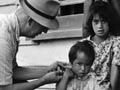 Doctor checking Māori family, 1950