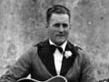 Oswald Cheesman (with guitar) and band members