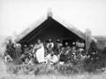 Māori outside a meeting house at Waipahihi, with Te Rangitāhau standing at the front