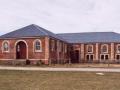 Large brick building in empty field
