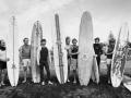 Group of men holding surfboards on beach